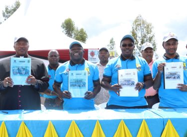 The Bishop, The Governor and Program Directors displaying the signed Design documents.